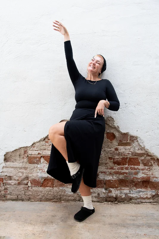 Wrap Midi Skirt In Black flowy skirt hem